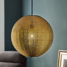 a golden ball hanging from a ceiling in a living room