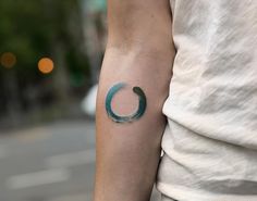 a person with a blue circle tattoo on their arm