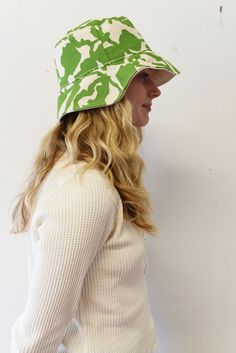 The perfect lightweight bucket hat for sunny spring and summer days! Now available in two sizes (Small/Medium & Large) since we had some issues with these not be consistent last season. Print: 1 color screen print Size: Small/Medium 21-22.5 inches, Large 22.5-23 inches (inside circumference) Material: Cotton, Cotton Canvas Lining Care: Hand Wash Cold. Hang or Lay Flat to Dry. Do not dry in the dryer. Casual Bucket Hat With Uv Protection And Flat Brim, Casual Bucket Hat With Uv Protection Flat Brim, Casual Bucket Hat With Upf 50+, Playful Cotton Bucket Hat With Short Brim, One Size Flat Brim Bucket Hat With Uv Protection, Fun Summer Bucket Hat With Curved Brim, Trendy Bucket Hat With Upf 50+, Fun Green Sun Hat For Summer, Trendy Summer 5-panel Hats