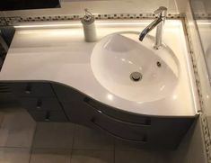 a white sink sitting on top of a bathroom counter