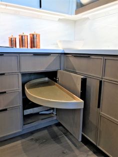 an open cabinet in the middle of a kitchen