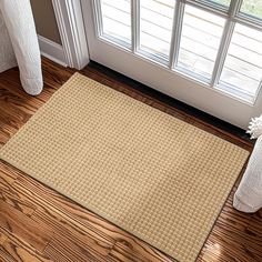 a door mat sitting on the floor in front of a window