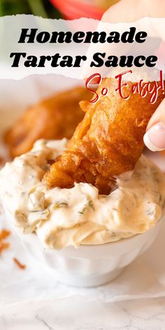 homemade tartar sauce in a white bowl with a hand dipping it into the dip