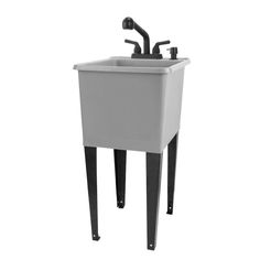 a white sink sitting under a faucet on top of a wooden stand with black legs