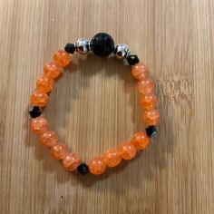 This Listing Is For A Handcrafted Orange, Black And Silver Beaded Stretch Bracelet. Perfect For Halloween The Orange Beads Are 6mm Glass Beads. The Focal Bead Is A Black 10mm Bead. The Silver Beads Are 6mm Stainless Steel Beads. The Black Bicones Are 4mm. They Are Strung On A 1 Mm Elastic Cord. It Is 6.5” Which Fits 6 -7 Inch Wrist. Handmade By Me. Wear This Beautiful Bracelet Single Or In A Stack. It Is Perfect And Comfortable For All Day, Everyday Wear Or Special Occasions. Very Pretty Dainty Handcrafted Bracelets, Halloween School, Beaded Stretch Bracelet, Focal Bead, Stretch Bracelets, Orange Black, Silver Beads, Womens Jewelry Bracelets, Beautiful Bracelet