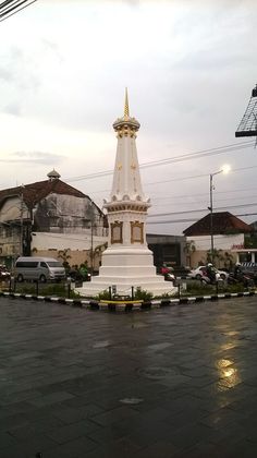 a large white monument sitting in the middle of a parking lot