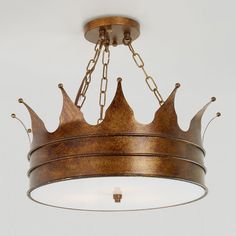 a chandelier with three crowns hanging from it's sides and two lights on each side