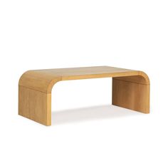 a wooden bench sitting on top of a white floor next to a table with an open end