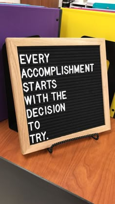 a sign that says every accomplishment starts with the decision to try on top of it