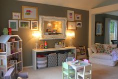 a living room filled with furniture and pictures on the wall