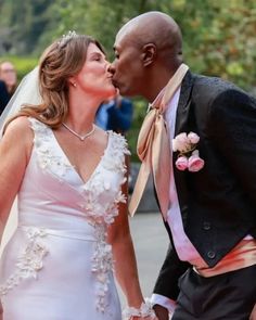 a bride and groom kissing each other on their wedding day