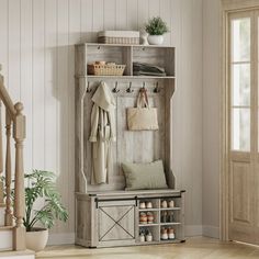 an entryway with a coat rack and shoes on the floor next to a stair case