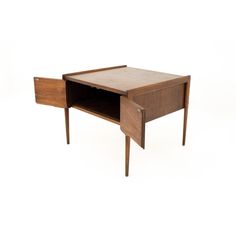 a small wooden desk with one drawer open