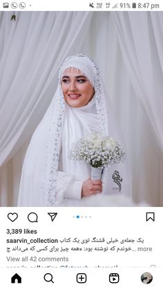 an image of a woman wearing a veil and holding a bouquet of flowers in her hand