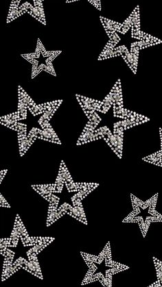 many silver stars on black background