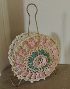 a crocheted doily hanging from a hook