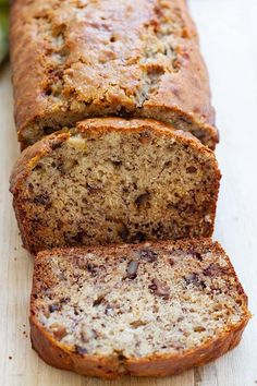 a loaf of banana bread sitting on top of a wooden cutting board