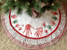 a christmas tree skirt with hand prints on it