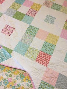 two quilts are laying next to each other