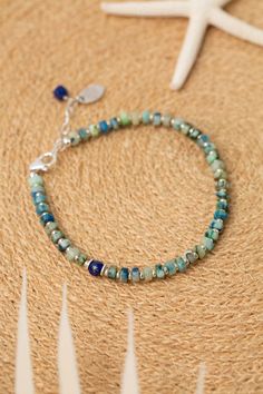 Indulge in the beauty of the sea with our Pacifica Collection! Each piece is meticulously handcrafted with stunning shades of blue, capturing the essence of ocean waves and clear skies. Sterling Silver (Lead & Nickel Free) Lapis Lazuli, Jasper 7.5-8.5" adjustable with sterling silver lobster claw clasp We hand select our natural materials, thus there may be slight variations in color and/or size that will not detract from the overall aesthetic. Our unique handcrafted designer jewelry for women i Artisan Blue Bracelets For The Beach, Blue Rondelle Beaded Bracelets With Polished Beads, Blue Artisan Adjustable Beaded Bracelet, Artisan Blue Beaded Bracelets For Beach, Bohemian Blue Bracelets With Natural Stones, Bohemian Blue Bracelet With Natural Stones, Adjustable Artisan Blue Beaded Bracelets, Adjustable Blue Artisan Beaded Bracelets, Bohemian Summer Jewelry In Ocean Color