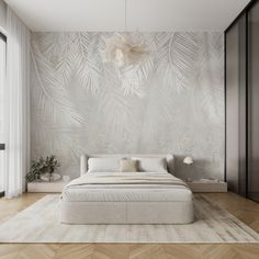 a bedroom with a large bed in front of a wallpapered background that looks like palm leaves