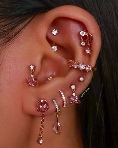 a close up of a person's ear with several different types of piercings