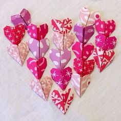 paper hearts are arranged in the shape of a heart