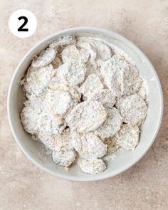 a bowl filled with powdered sugar on top of a table