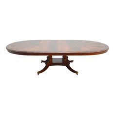 an oval dining table with two leaves on each end