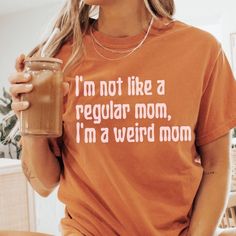 🩴 I'm not like a regular mom, I'm a weird mom. So much better than being a mean girl or a cool mom. 🩴 Click here to view our shop for more great designs --- https://www.etsy.com/shop/GraceAndFlipFlops Click on the ❤️ to see our new designs as they arrive. 🩴 Comfort Colors T-Shirts - Made with 100% ring-spun cotton. The soft-washed, garment-dyed fabric brings extra coziness to your wardrobe while the Unisex relaxed fit makes it an excellent daily choice. The double-needle stitching throughout Funny Print Shirt For Mother's Day, Funny Shirt With Print For Mother's Day, Casual Shirt With Funny Print For Mother's Day, Mother's Day Cotton Shirt With Funny Text, Funny Pre-shrunk Tops For Mother's Day, Funny Cotton Shirt For Mother's Day, Mother's Day Funny Shirt With Letter Print, Fun Cotton Shirt For Mother's Day, Weird Moms Build Character