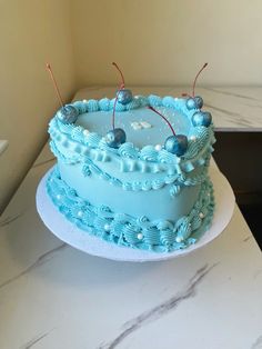 a blue cake sitting on top of a white plate