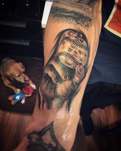 a person with a baseball tattoo on their arm