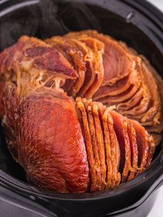 the ham is cooked in the slow cooker and ready to be served for consumption