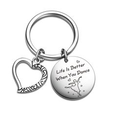 a keychain with a heart and an inscription that says life is better when you dance