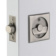 a close up of a door handle on a white door with silver knobs and an electronic lock