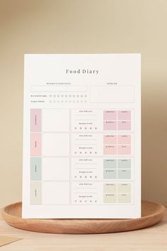 a printable food diary sitting on top of a wooden plate