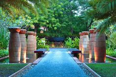 an outdoor garden with water features and palm trees