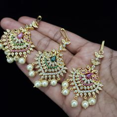 "Handmade Indian Temple Jewelry, best to wear it for traditional ceremonies or Indian weddings. This bridal jewelry has an ethnic finish. It has Cubic Zircon stones with ruby and emeralds. It is a Bollywood style one gram jewelry. There are long and short patterns of Indian jewelry in Kundan, Pearls, CZ, American Diamond, ruby, emerald, Polki, kemp to suit every occasion of South Indian and North Indian weddings. When you adorn mang tikka on your forehead, it will bring out the real beauty of an Traditional Bridal Sets With Tilla, Traditional Meenakari Bridal Accessories, Traditional Bridal Accessories With Stone Work For Festive Occasion, Traditional Ceremonial Bridal Sets With Stone Work, Traditional Bridal Sets With Stone Work For Ceremonial Occasion, Traditional Bridal Sets With Stone Work For Ceremonies, Traditional Bridal Sets For Ceremonies And Festivals, Traditional Gold Tikka For Ceremonies, Traditional Stone Work Bridal Accessories For Festivals