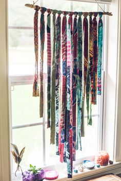 a wind chime hanging from a window sill