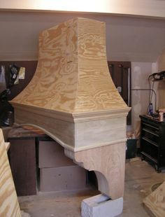 a wooden stove top sitting on top of a table