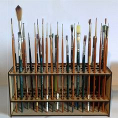 there are many brushes in the holder on the shelf and one is full of them