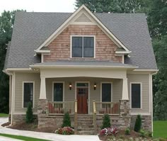 a small house with stone and brick accents