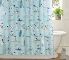 a blue shower curtain with cartoon characters on it in front of a white bath tub