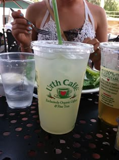 a woman sitting at a table with drinks