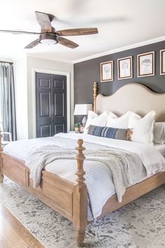 a bedroom with a bed, ceiling fan and pictures on the wall