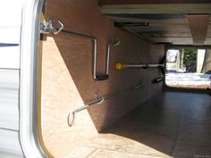 the inside of an rv with its door open and some metal bars on the side