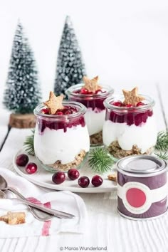 three desserts in glass jars with cranberry sauce and star decorations on top