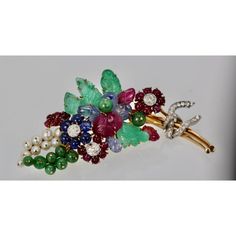 This is part of Chairish’s Fine Jewelry assortment.  Gem set Diamond Brooch w/Certificate 18K  This gorgeous gem set Diamond brooch is a bit Tutti Frutti plus. This brooch is large 8.5 cm long or 3 1/4" at the widest it is 3 cm and it weights 34.4 grams. The brooch consists of (4) Green Emerald carved leaves, (8) round beads, (4) Ceylon Sapphire carved leaves, (3) carved Ruby leaves, 20 small Ruby beads, (6) deep Blue Sapphires, (9) pearls cultured and numerous Diamonds all on 18K yellow gold. This comes with a certificate stating the Jade is real as are the stones. This is very special and a piece you will hold on to for life. Just exquisite. Do not wait or you will be too late this is a very special piece I purchased through Sothebys Auction House.  Please reference the measurements note Formal Multicolor Gemstone Brooches, Luxury Multicolor Gemstone Brooches, Luxury Multi-stone Brooches For Anniversary, Elegant Multicolor Gemstone Brooches, Formal Multi-stone Brooch Fine Jewelry, Formal Multi-stone Brooches In Fine Jewelry Style, Formal Multi-stone Brooch In Fine Jewelry Style, Elegant Multi-stone Brooches For Formal Occasions, Elegant Multicolor Brooches For Evening