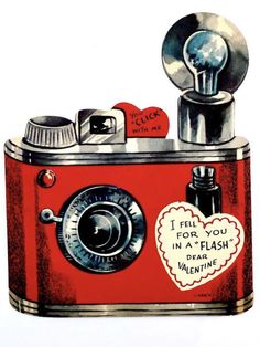 a red camera with a heart shaped sticker on it