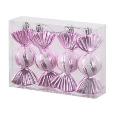 pink ornaments in a clear box on a white background